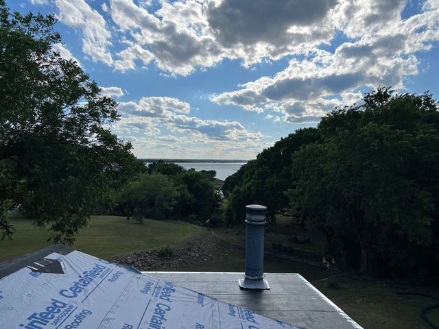 Weatherford, TX — flat roof materials, ice and water shield and a custom circular boot for this chimney stack.